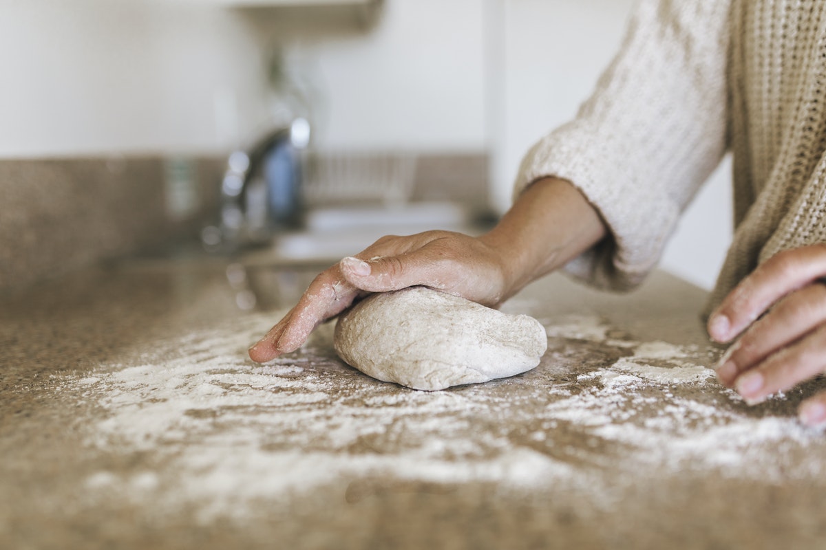 Woman kneading a sourdough in her kitchen